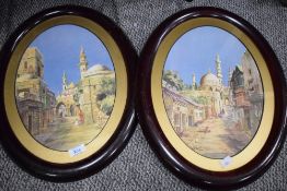 A pair of Arabic street scenes mounted framed and glazed in oval frames 46cm x 36cm.
