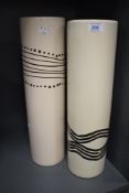 A pair of cylindrical ceramic vases, decorated having tribal patterns on a cream ground, h43cm