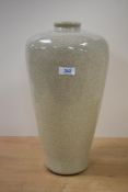A large 20th century colossal style ceramic vase, decorated in crackle glaze on a cream ground,