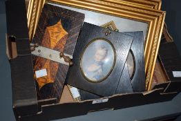 A carton of assorted small pictures and prints.