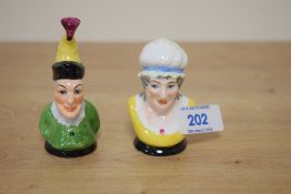A pair of Royal Worcester style condiments in the form of Punch and Judy.