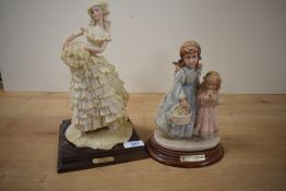 An Auro Belcari figurine of a girl with a flower basket and another similar of two girls with