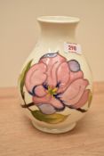 A Moorcroft Pottery Hibiscus pattern vase, of ovoid form with slightly flared rim and circular foot,