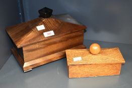 A 20th century mahogany tea caddy, of sarcophagus form with unusual sliding cover and screw