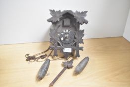 A vintage German Black Forest style cuckoo clock, having carved leaf and pine decoration, H20cm, A/