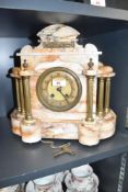 A victorian 8-day varigated marbel mantel clock having brass dial flanked either side with Doric