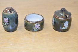 A Royal Doulton stoneware three piece condiment set comprising of mustard pot, shaker and small pot,