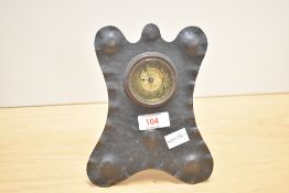 An Art & Craft copper mantel / desk clock of planished design, the circular gilt dial having