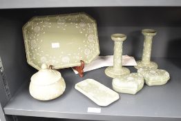 A pair of Harry Barnard (1862-1933) Wedgwood candlesticks decorated with floral patterns on a