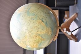 A World Master Globe supported on teakwood legs, h44cm