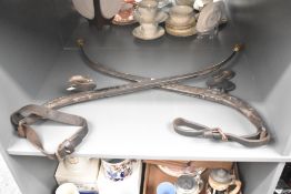 A pair of steel and brass horse collar Haymes with leather reins, L74