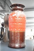 A 20th century West German pottery vase, of cylindrical form having a flared rim with circular