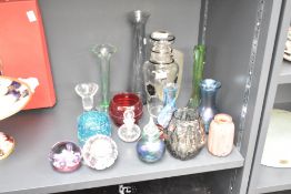 A collection of seventeen glass vases, paperweights, and scent bottles, including Caithness,