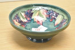 A Moorcroft pottery leaf and berry pattern bowl, impressed and painted mark to base, h7cm