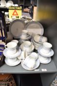 An Atlas Bone China Grimwades part dinner service, decorated having floral pattern on a white