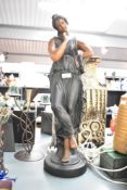 A large cast ceramic sculpture of a young classical maiden lady wearing a full toga dress, h63