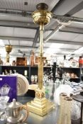 A early 20th century telescopic brass Corinthian column oil lamp, supported on a three step base,