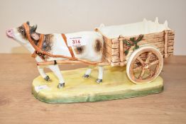 A Czechoslovakian Pottery cow and trap centrepiece, impressed mark to base 32.5cm wide