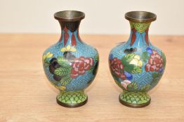 A pair of small 20th century Chinese cloisonné enamel vases, decorated with blossoms and repeating