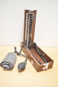 A vintage wooden cased blood pressure reader, by Accoson