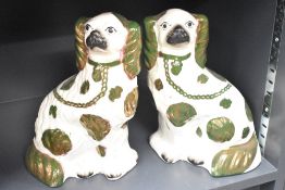 A pair of early 20th century Staffordshire pottrery spaniels, h26cm