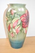 A Moorcroft pottery Hibiscus pattern vase of ovoid form, decorated with red and purple foliage on a