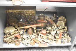 A large group of brass and copper ware, to include a door knocker, bell, candlesticks, tea pot ect