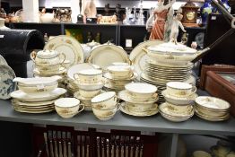 An early 20th century Noritake Green 'M' pattern dinner service, decorated with gilt and floral