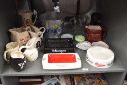 A Corona galvanised beer ice bucket, h18cm, sold together with a Bell's Scotch Whiskey jug, a