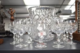 A collection of twelve Riedel cut glass wine glasses, along with an Irena lead crystal wine cooler