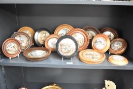 Fifteen wooden mounted ceramic Pratt ware, pot lids, having decorative scenes and three with