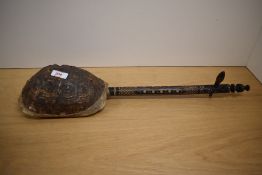 A tortoiseshell Gunibri guitar, the neck decorated with geometrical folk art patterns, L58cm