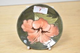A Moorcroft pottery Hibiscus pattern dish, impressed makers mark to base, h11.5cm