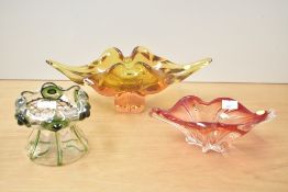 A Czechoslovakia style hand blown red glass dish of organic form, w21cm, sold together two other