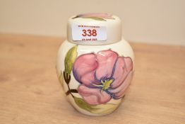 A Moorcroft Pottery Hibiscus pattern ginger jar, of traditional design and tube-lined with
