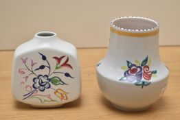 A vintage Poole pottery vase, decorated with floral patterns on a white ground, h13cm, sold together