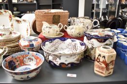 A Chinese wicker tea cased set having ceramic tea pot and bowl, decorated with gilt edging and