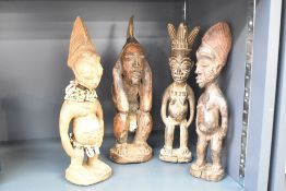 A hand carved Tribal African ritual figure, decorated wearing multicoloured bead and shell neckless,