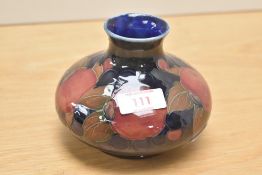 A Moorcroft pottery Pomegranate pattern vase, of bulbous form with dark indigo blue glaze, impressed