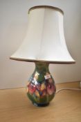 A Moorcroft pottery Iris pattern table lamp of baluster form, decorated with floral patterns on a