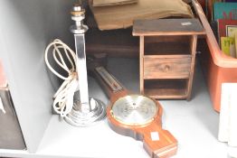 A vintage chrome column lamp supported on a three step base, h32cm, sold together with a barometer