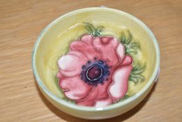 A Moorcroft pottery Anemore pattern bowl decorated with red foliage on a yellow glaze ground,