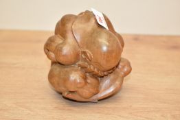 A carved hardwood weeping Buddha figure