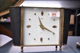 A Smiths retro 8 day mantel clock, having faux leather chapter and brass hands, raised on brass