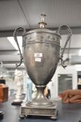 A large white metal Samorar, of tapering cylindrical form having decorative scroll handles, with