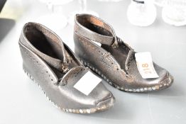 A pair of Victorian children's leather clogs having wooden sole and nail stitching, L12.5cm
