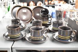 A vintage pottery tea set decorated having a green ripple base on a dark blue/green glaze ground, (