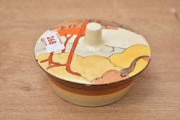 A Clarice Cliff Biyance pattern lidded dish, hand coloured having an orange and yellow landscape