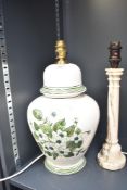 A ceramic Portuguese table lamp, hand coloured with green floral patterns on a glaze ground,