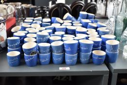 A group of Devon studio pottery egg cups decorated with town names, to include Manchester, Fort